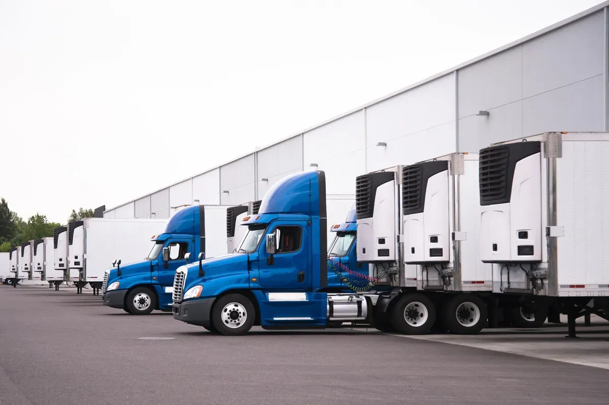Fleet of trucks lined up at a distribution center